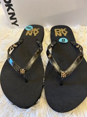 DKNY Black Flip Flop Sandals with Gold Logo Accent